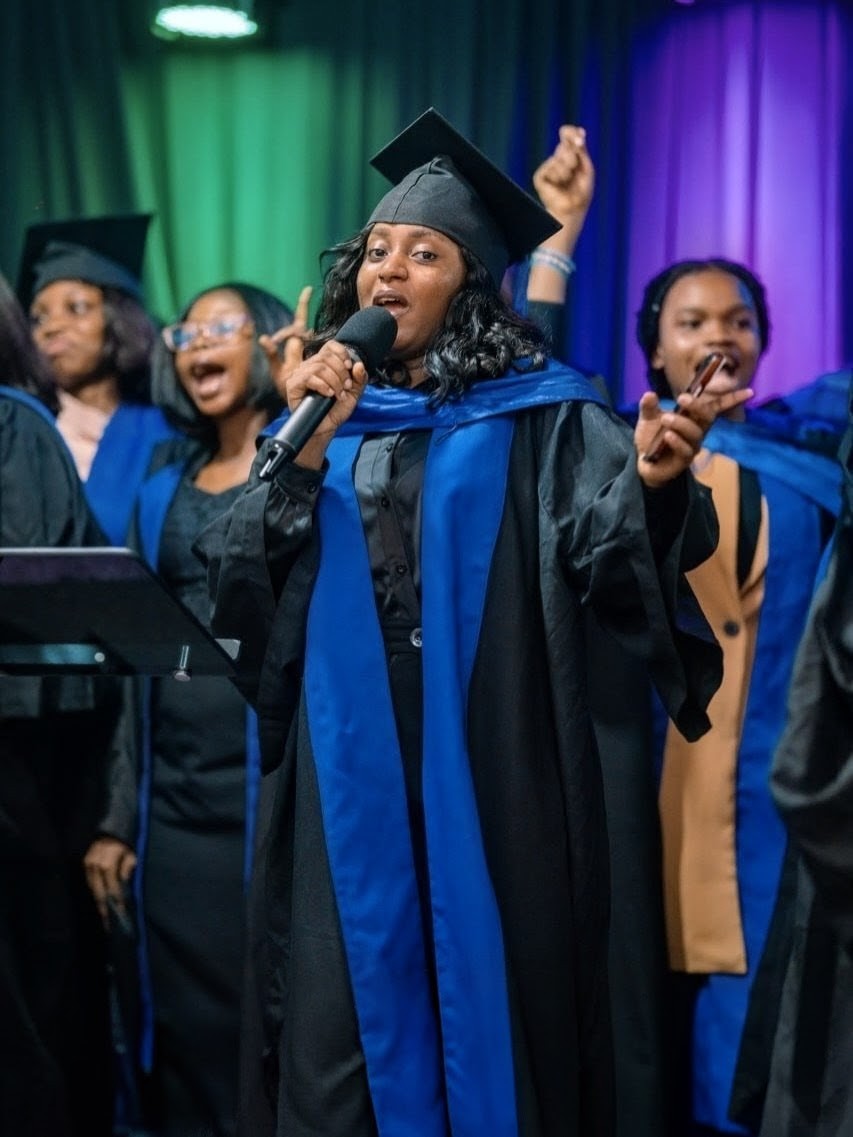 A DGC minister leading worship during a service